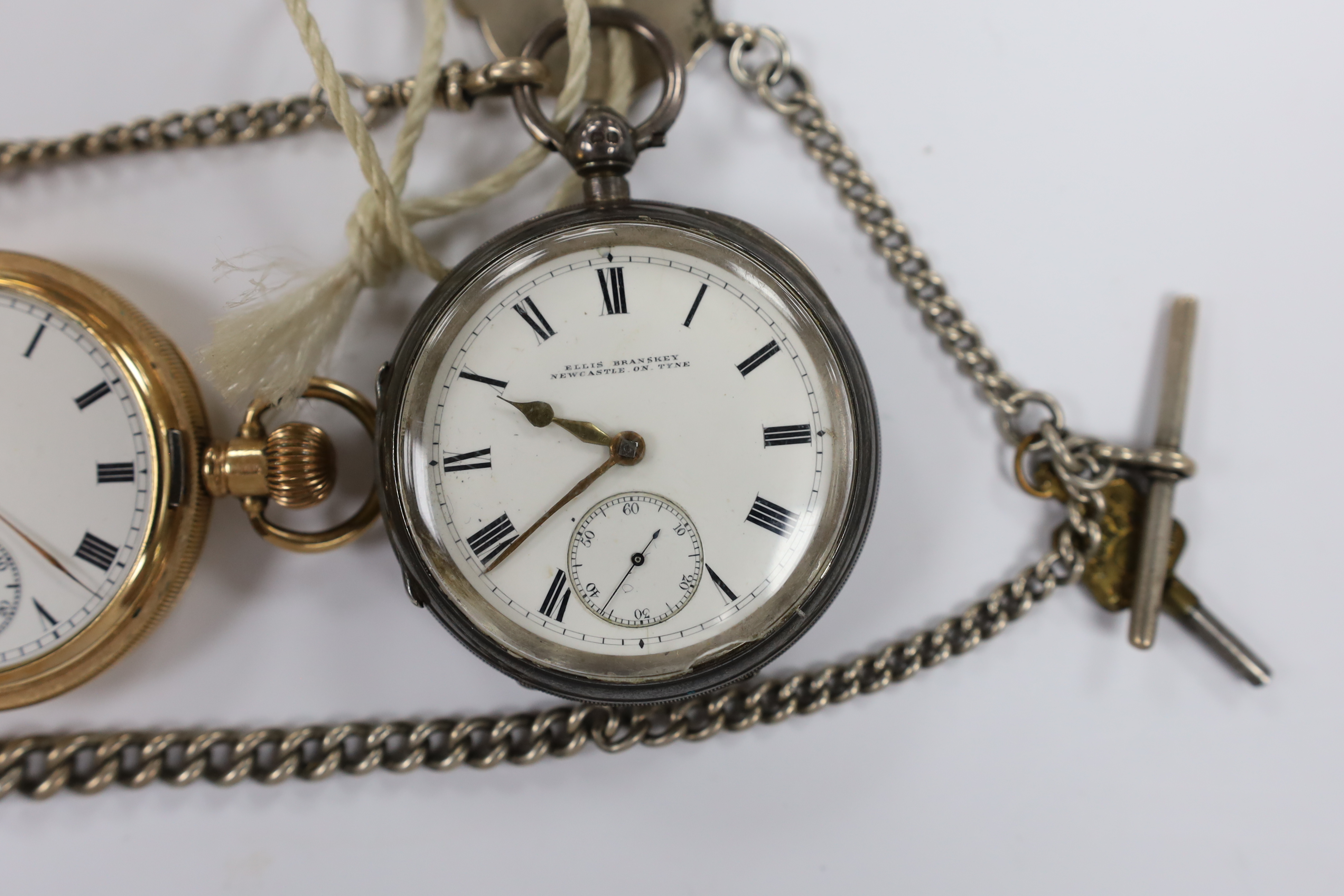 A George V silver open face keywind pocket watch by Ellis Branskey of Newcastle, on a graduated silver curb link albert, together with a gold plated Waltham hunter pocket watch and a Swiss 935 white metal half hunter fob